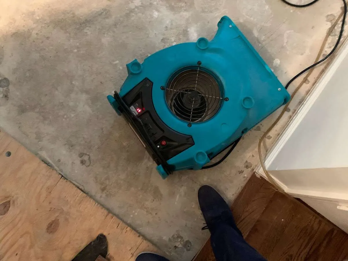 Air mover drying subfloor during Commercial Water Damage Restoration in Twinsburg